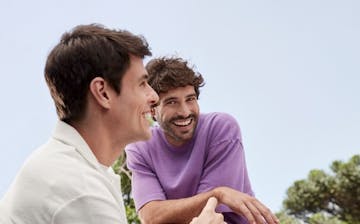 Dois homens conversando em um ambiente externo