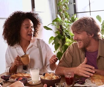 Two people eating and talking