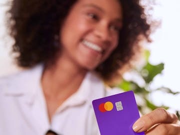 Woman holding nubank card