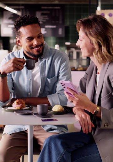 white man smiling holding his phone